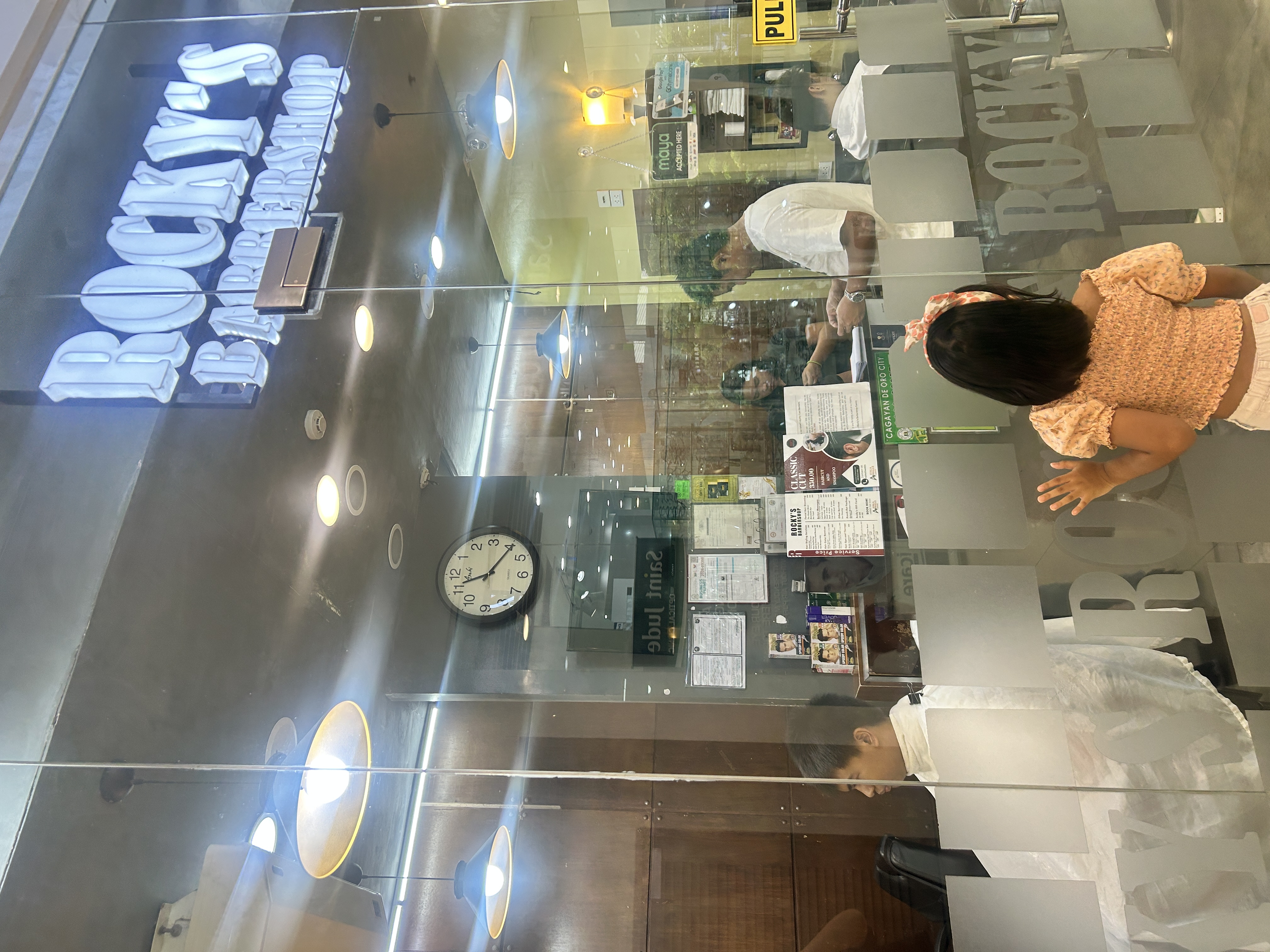 oli peeking at rocky's barbershop